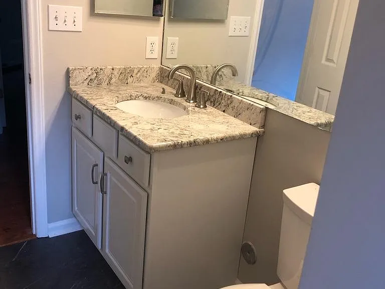 Hall bath. New vanity, granite, light fixtures and tile floors