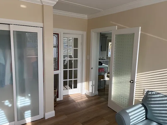 Living room with view into kitchen....French door into in-unit Laundry Room