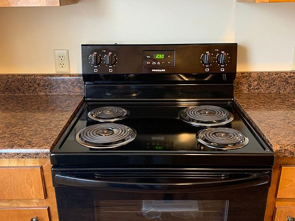 Electric Coil top stove and vent hood.