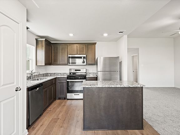 The beautiful kitchen has wood cabinetry.