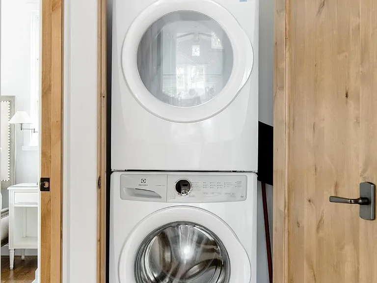 stackable laundry neatly tucked behind a door
