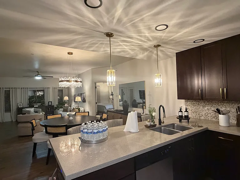 Open kitchen area with a 6 chair / round table dining and living area.