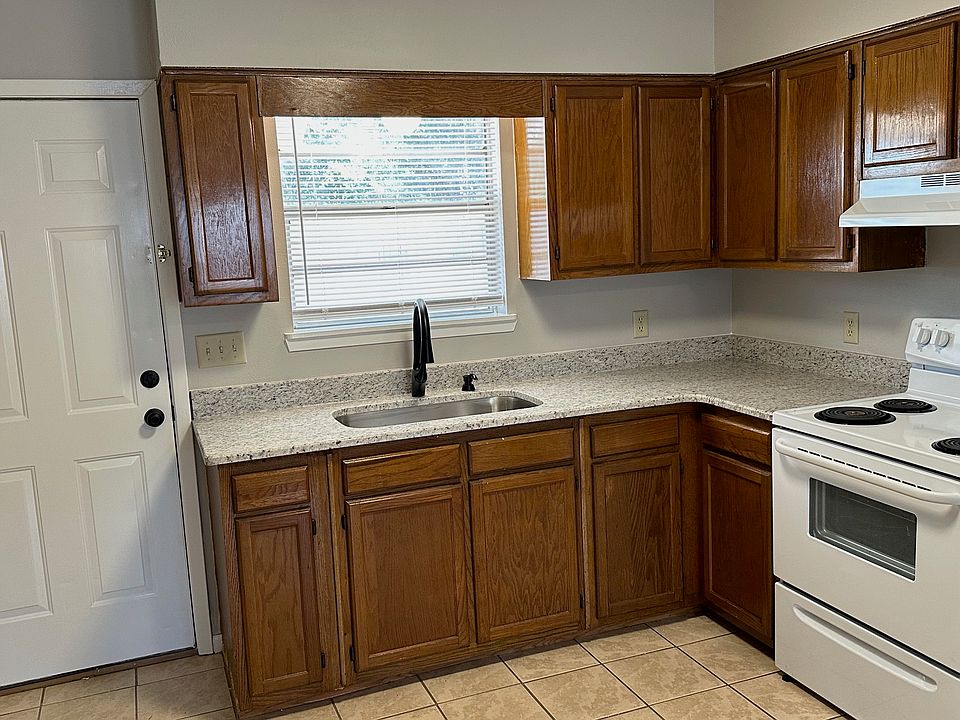 Kitchen view with sink and window with outside view. New granite countertops.
