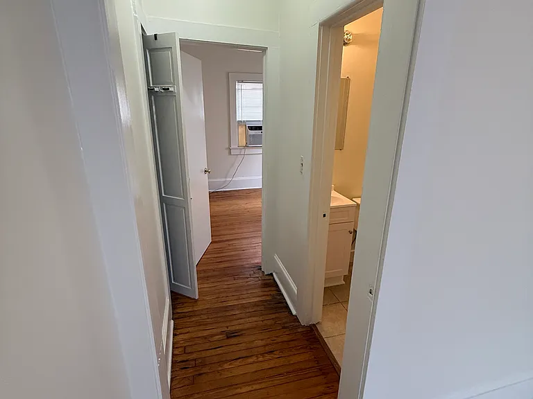 Hallway from kitchen to the bathroom and second bedroom in the back.