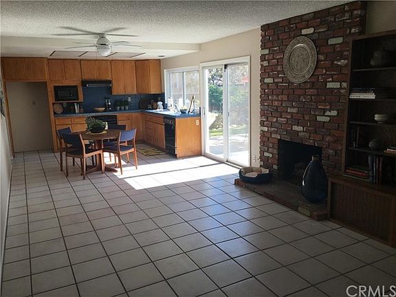 Family room with fireplace is open to the kitchen.