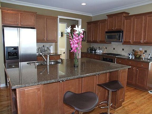 Kitchen with island and stainless steel appliances, granite counter tops