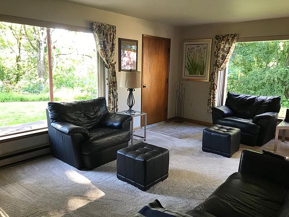 Living room has large windows to enjoy the private space outside.