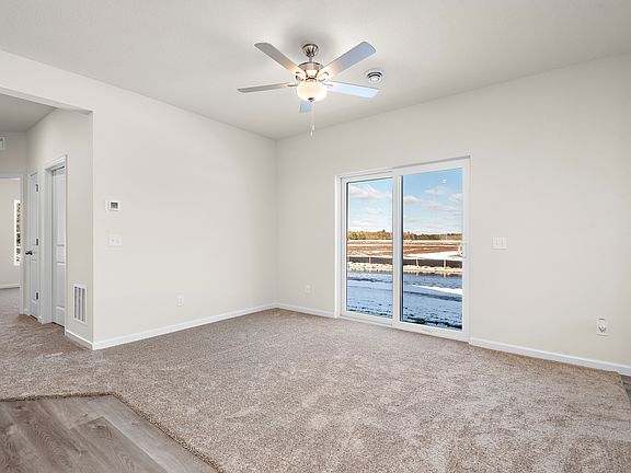 The family room is spacious with a ceiling fan.