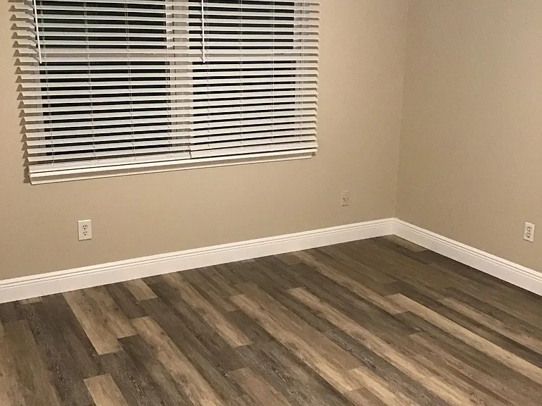Bedroom 1, window overlooks patio and water