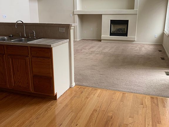 Kitchen Hardwood Floor into Family room with Fireplace