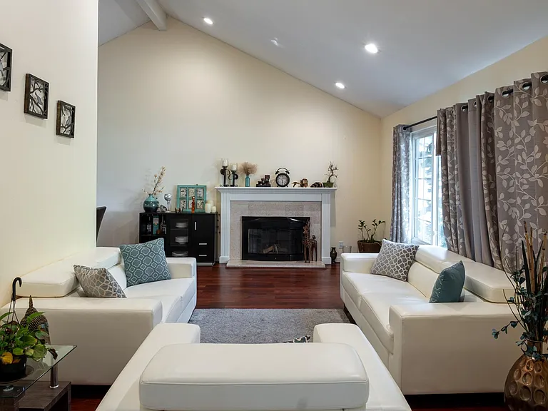 Living room with high ceiling and recess lighting