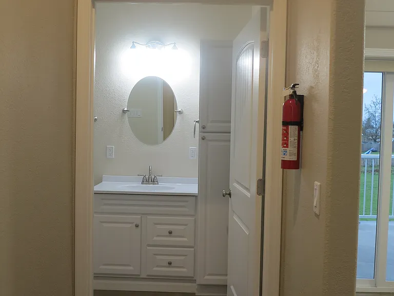 Hallway transitioning into the bathroom.
