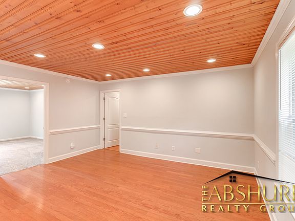 Living room with custom tongue and groove ceiling, chair rail and LED recessed lighting
