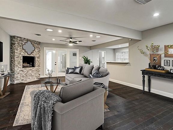 The Family Room overlooks the Fireplace, and yes, I do love a Fireplaces, it makes a room feel so cozy. To the Right is the Kitchen and beyond the doors is the outdoor kitchen/patio