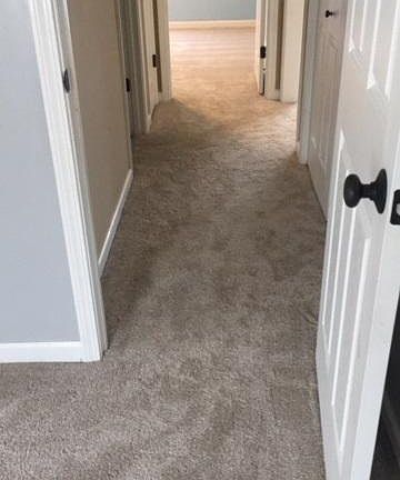 Hallway between 2 bedrooms w/bathroom in the middle.