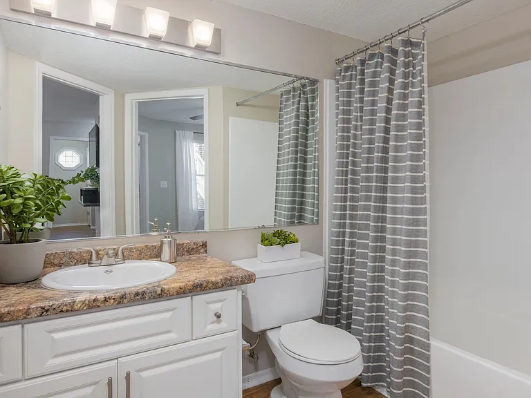 Partake in a realm of luxury with sleek, updated bathrooms offering ample counters and spacious mirrors.