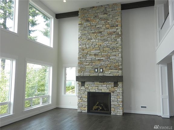 Full height stone fireplace with rough sawn mantle creates an impressive focal point for the Great Room.
