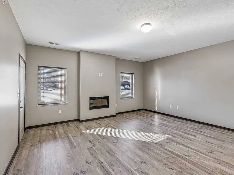 Large windows invite natural light, creating a bright and airy living space.