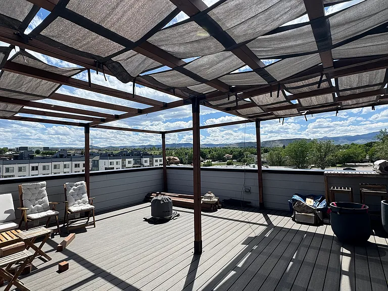 Our private 4th-floor rooftop oasis with mountain views. Please note: The temporary wooden pergola structure provides excellent shade but is currently undergoing property review and may be modified or removed prior to the lease start date.