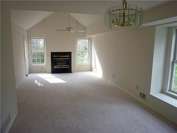 Open living and dining room with ceiling fan