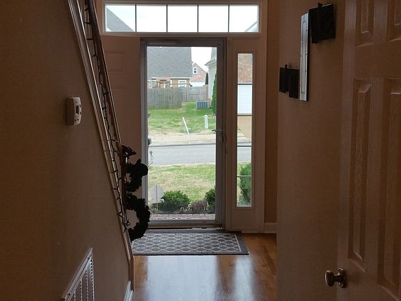 Looking out front door from family room, half bath on right.