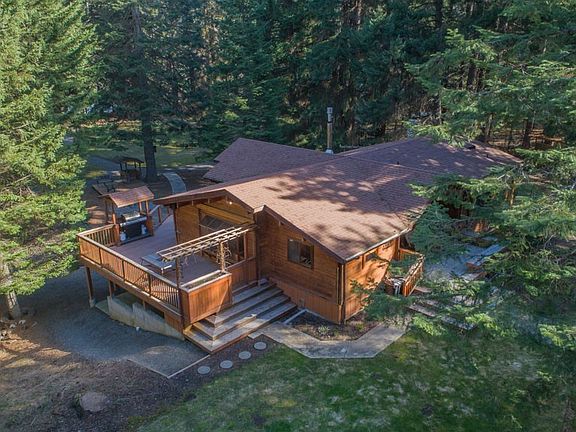 View of cabin with large deck, and covered BBQ area. Deck is facing south west for great afternoon sunshine and early morning shade as seen in this picture. 
