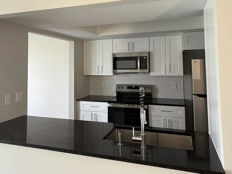 Fully equipped, recently remodeled kitchen with cabinets, granite counter-tops, stainless steel appliances, etc.