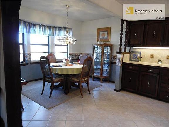 Breakfast area has tile floor and bay window overlooking back yard.