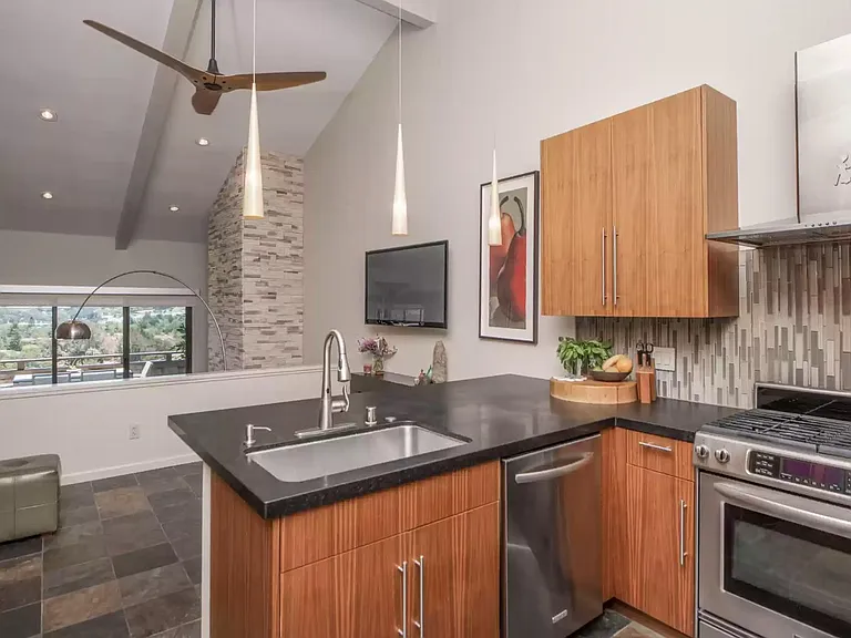 Kitchen and bonus area looking over great room