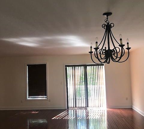 Open concept living and dining area with sliders to deck