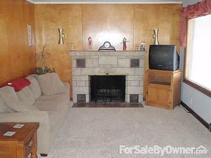 Living Room : Featuring natural wood burning fireplace.