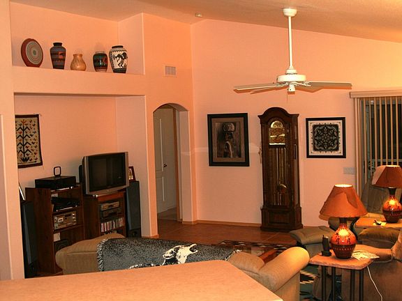 Great Room w/ entertainment niche, pot shelves, vaulted ceilings