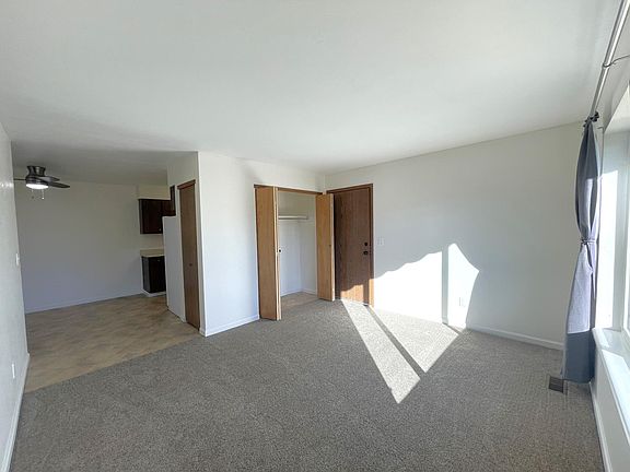 Living room, entry closet, and dining room
