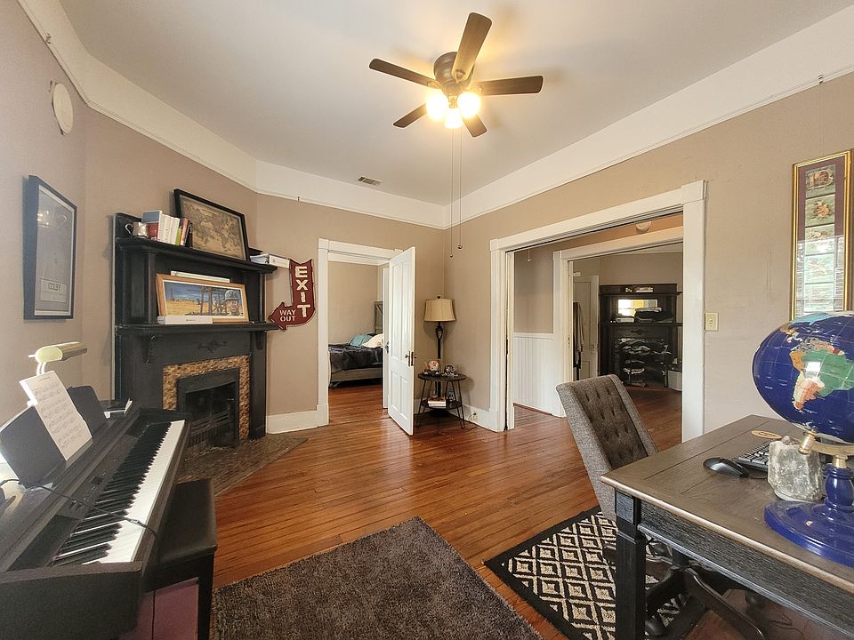 View from bathroom door into Back Parlor/Dining w view into back Bedroom, Hall, & Front Parlor/Living