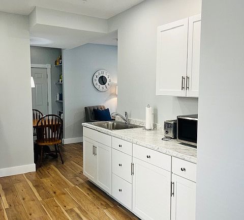 Galley kitchen with plenty of counter space, extra large sink, includes small appliances (microwave, toaster, and coffee maker).