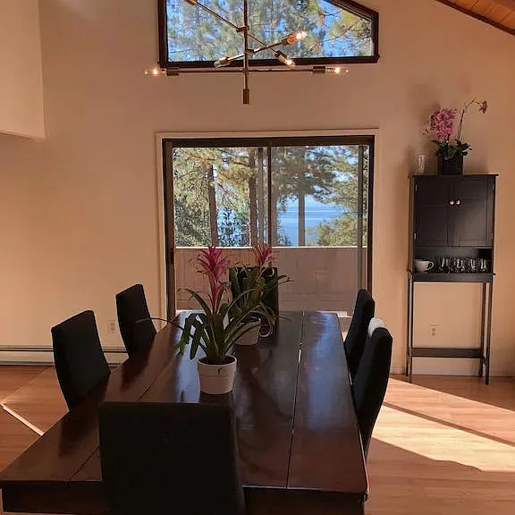 Dining room with hand made fruitwood table. Doors to lake view porch.