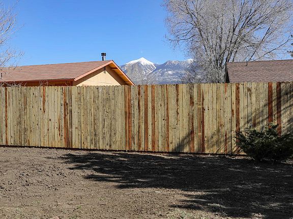 Peak view from backyard. New redwood picket fence (2020).