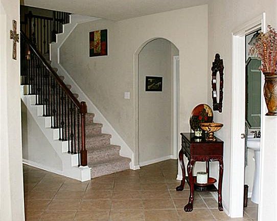 Open and inviting Foyer with high ceiling and beautiful tile leads to a Dining Room on the left and 