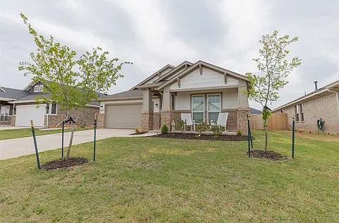 Street view with front porch sitting area and two-car garage