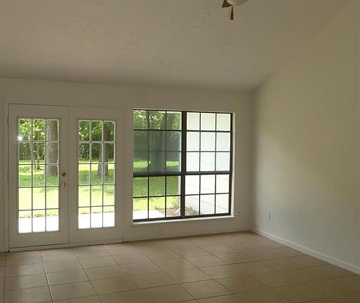 Wall of windows in the Living Room looks out into the huge back yard.
