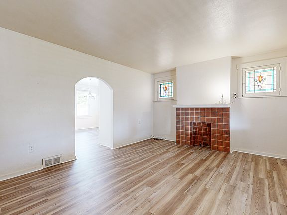 Living room, luxury plank floor and decorative fireplace, beautiful stained glass accents