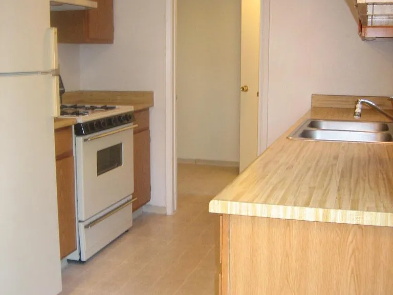 Kitchen With All Appliances, View Into Laundry Room With Was