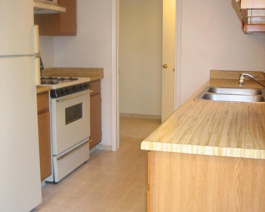 Kitchen With All Appliances, View Into Laundry Room With Was
