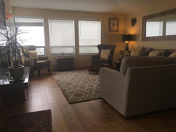 Living room with wood burning fireplace.