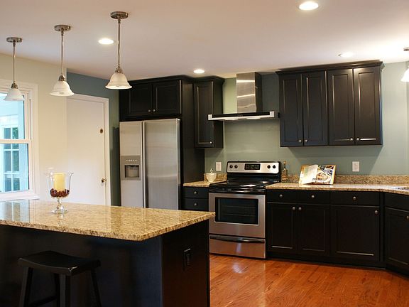 New kitchen with hardwood floors, granite counters and stainless appliances