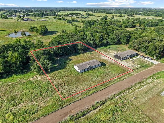Aerial view of sparsely populated area featuring property parcel outlined