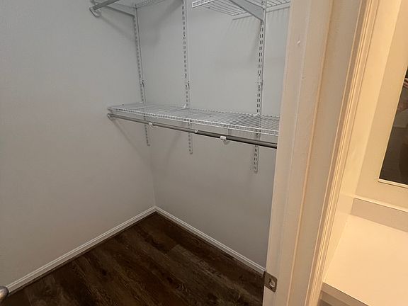 Primary bedroom walk in closet