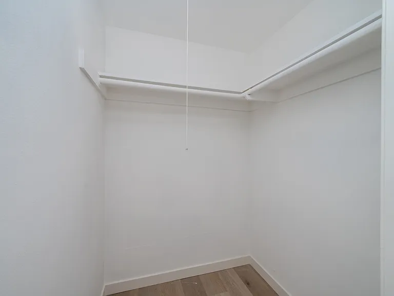 Walk-in closet in primary bedroom.