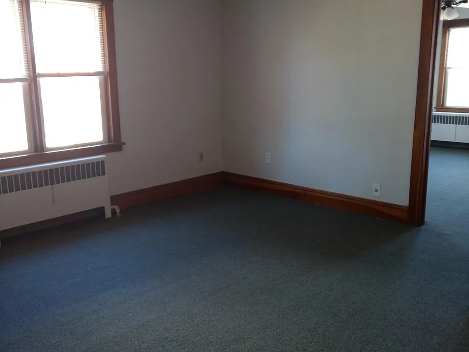 large living room with new carpet, freshly painted
