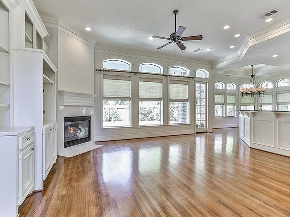 Abundant natural light in the family room, offering wall of windows which overlook the swimming pool and backyard.